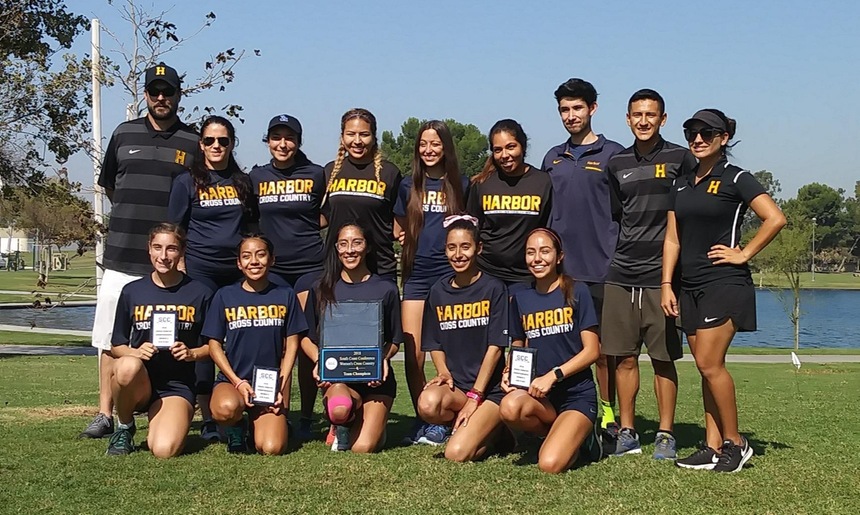 Geoff Skarr (far left) with his 2019 women's cross country conference champion team.